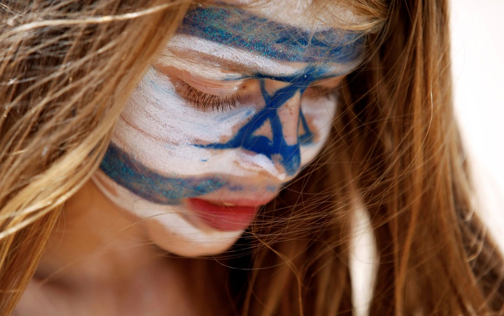 Jovem com a bandeira de Israel pintada no rosto, em Tel Aviv, em foto de 19 de abril — Foto: Reuters/Amir Cohen