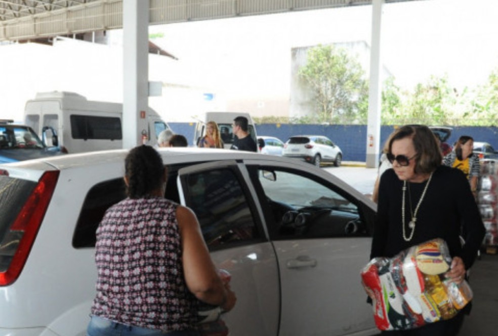 Diretora-presidente do Grupo Folha, Diva Abreu Barbosa, fazendo a entrega de donativos arrecadados em tradicional feijoada — Foto: Reprodução Folha de Campos