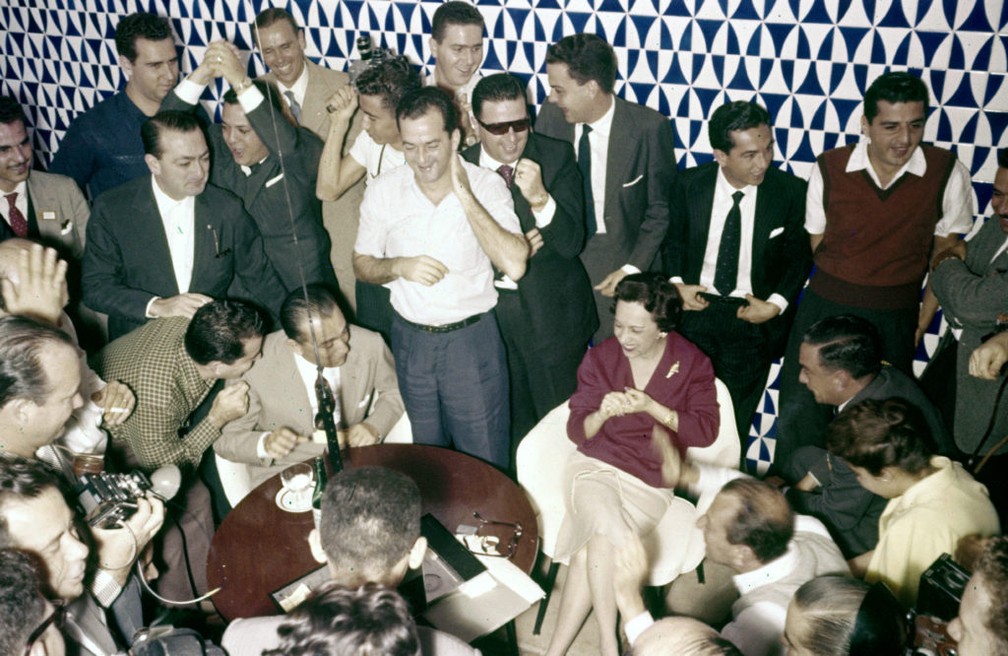 JK (sentado) e convidados acompanham, pelo rádio, jogo da seleção na Copa de 58 no Brasília Palace Hotel. — Foto: Arquivo Público do DF/reprodução