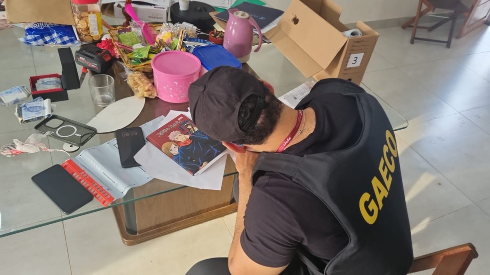 Oficial do Gaeco em um dos locais onde um dos mandados foi cumprido, em Sinop — Foto: Reprodução
