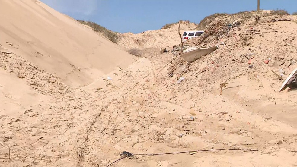 Dunas de areia estão cobrindo casa de moradores da Barra de Tramandaí, no Litoral Norte do RS — Foto: Reprodução/ RBS TV