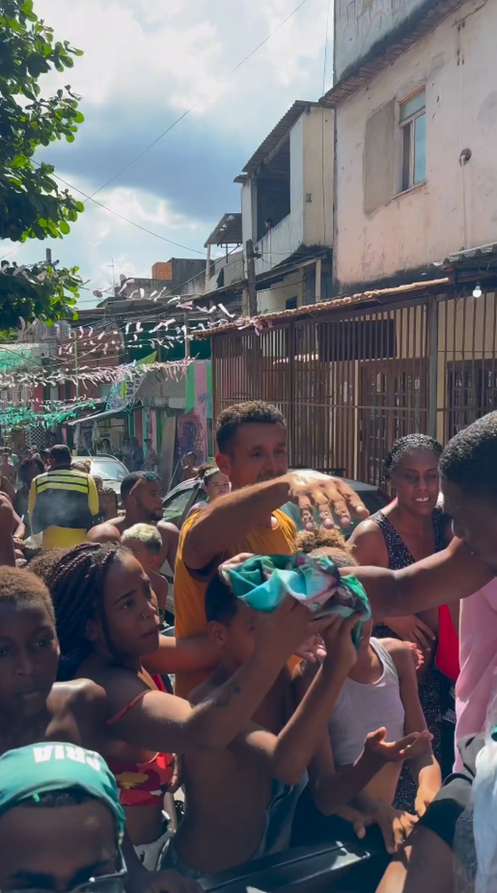 Mangueira distribui camisas e ingressos na comunidade para desfile em homenagem a Alcione — Foto: Reprodução