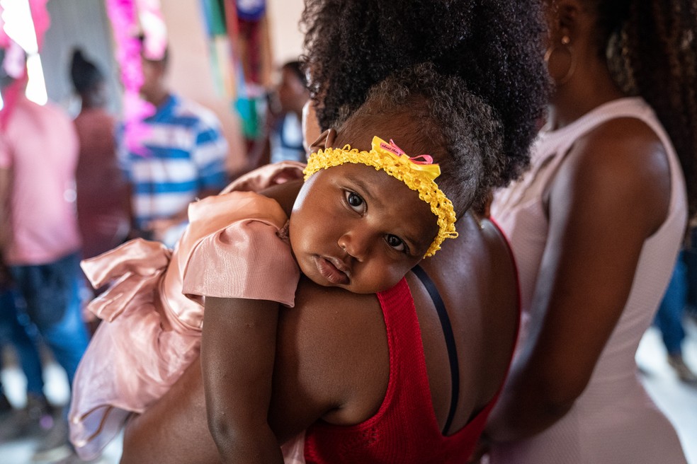 Criança sendo batizada na capela do Vão de Almas, no Quilombo Kalunga, em foto de 2019. — Foto: Fábio Tito/G1