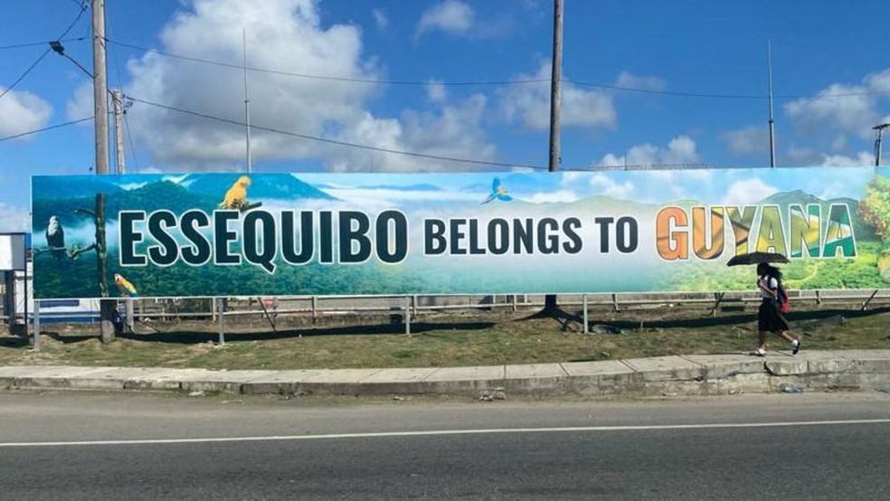 Cartaz em avenida de Georgetown com o slogan: 'Essequibo belongs to Guyana' (Essequibo pertence à Guiana, na tradução do inglês) — Foto: LEANDRO PRAZERES/BBC NEWS BRASIL